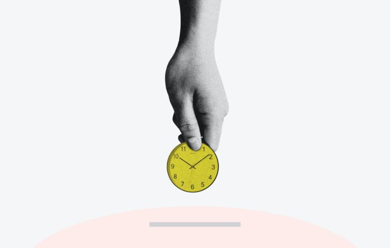 hand in black and white holding the top of a yellow clock