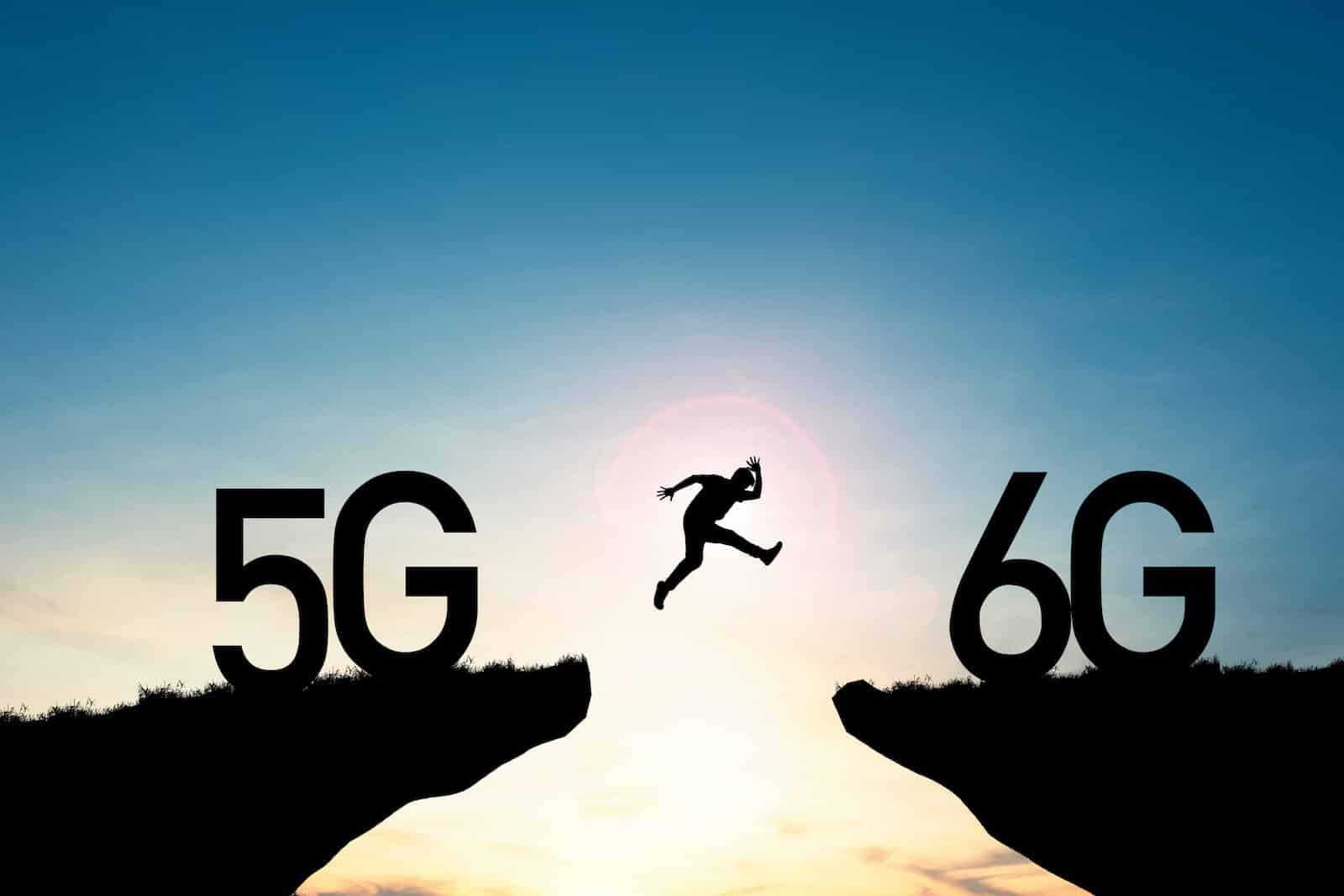 Man jumping from cliff with 5g sign to cliff with 6g sign