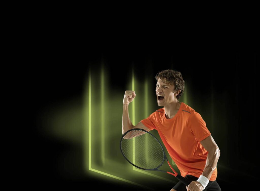 Tennis player shouting with arm up wearing an orange top