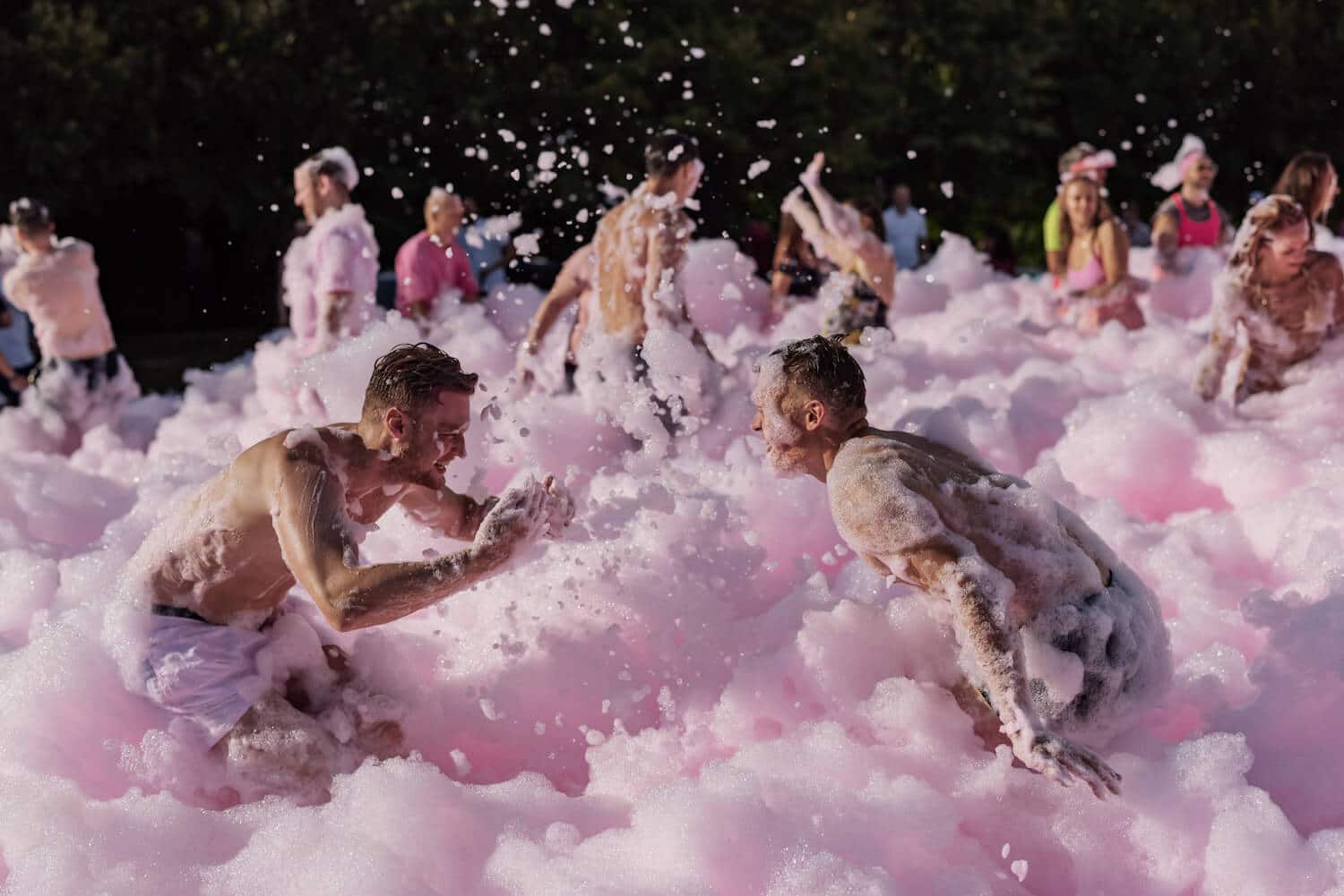 Zenitech employees having fun in a pink foam party