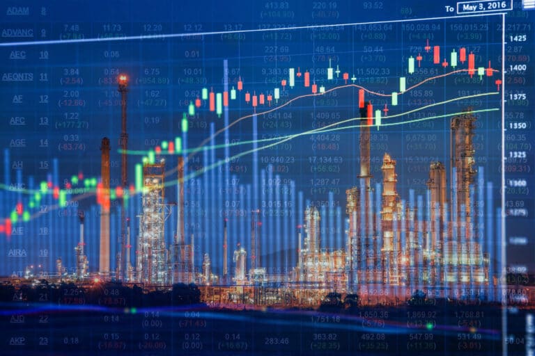 Candlestick chart superimposed onto a window overlooking a city skyline at night