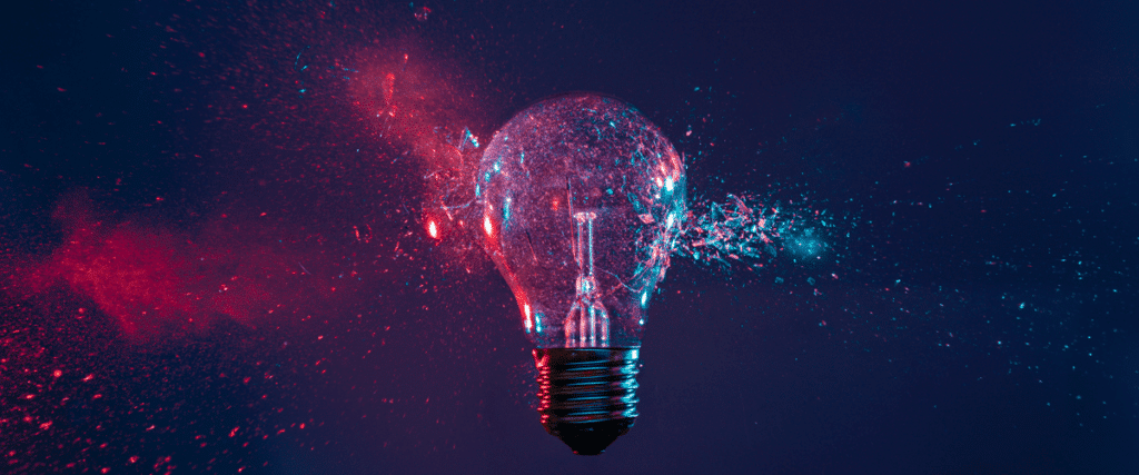 Red and blue lightbulb smashing on dark background