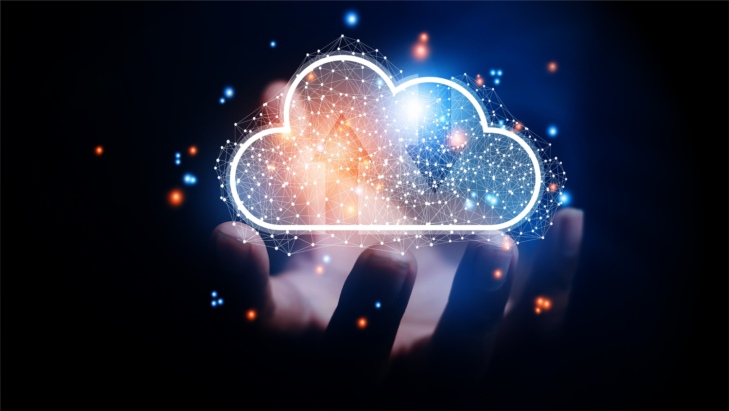 A glowing digital cloud icon composed of interconnected nodes and lines, floating above an open human hand in a dark background. The image symbolizes cloud computing, data storage, or digital technology. Blue and orange light particles surround the cloud, enhancing the futuristic and technological theme.
